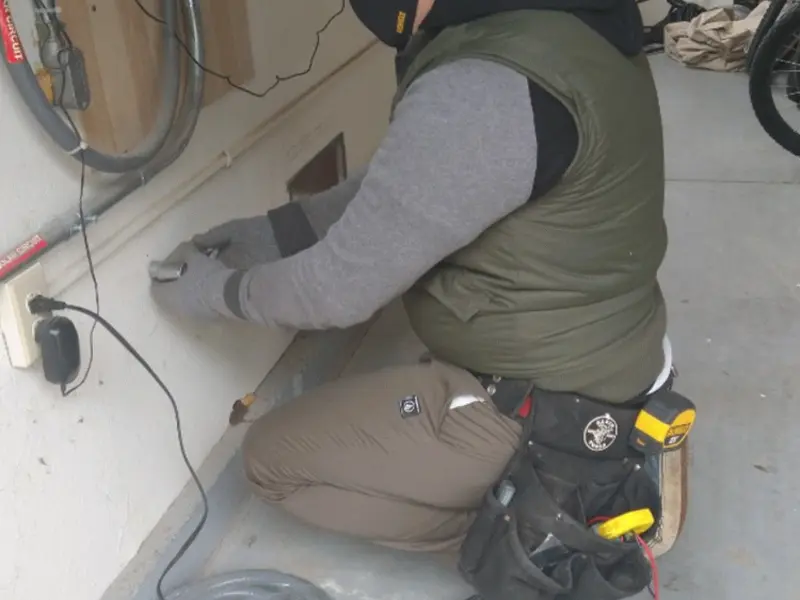 Electrician performing outlet wiring in a Swarthmore garage